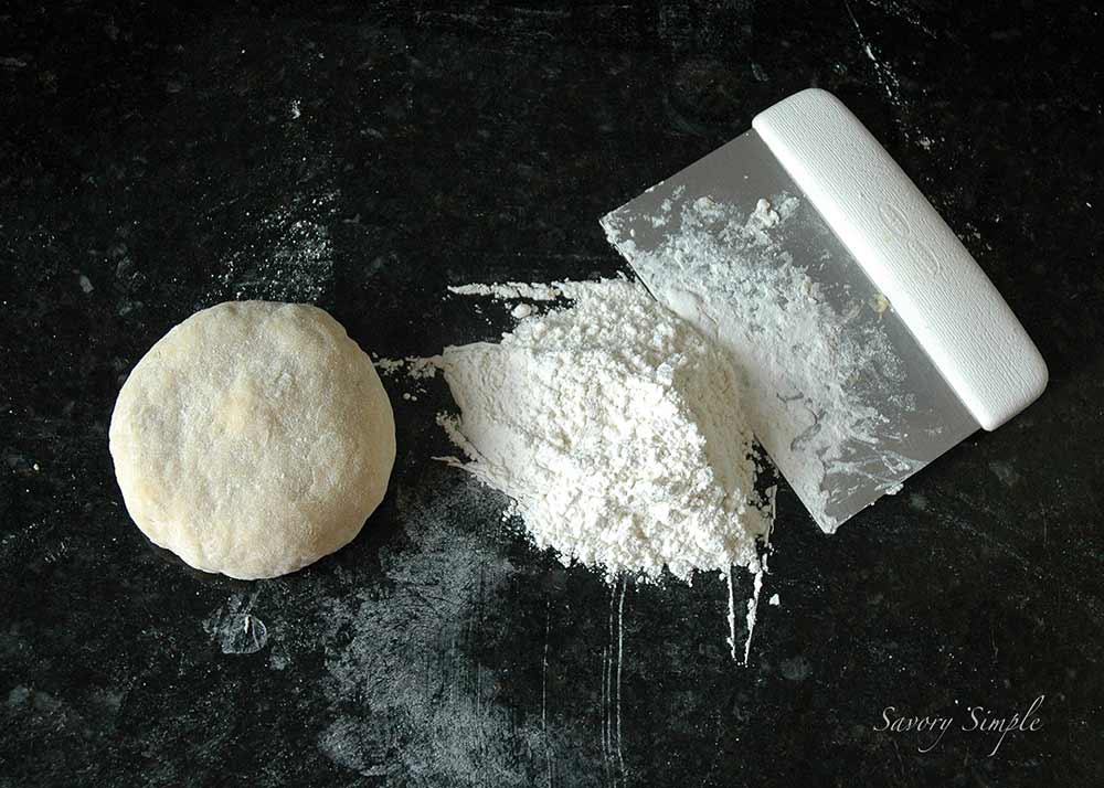 fresh pasta dough with a bench scraper