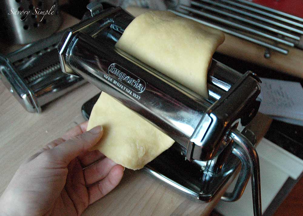 fresh pasta pulled through a pasta machine