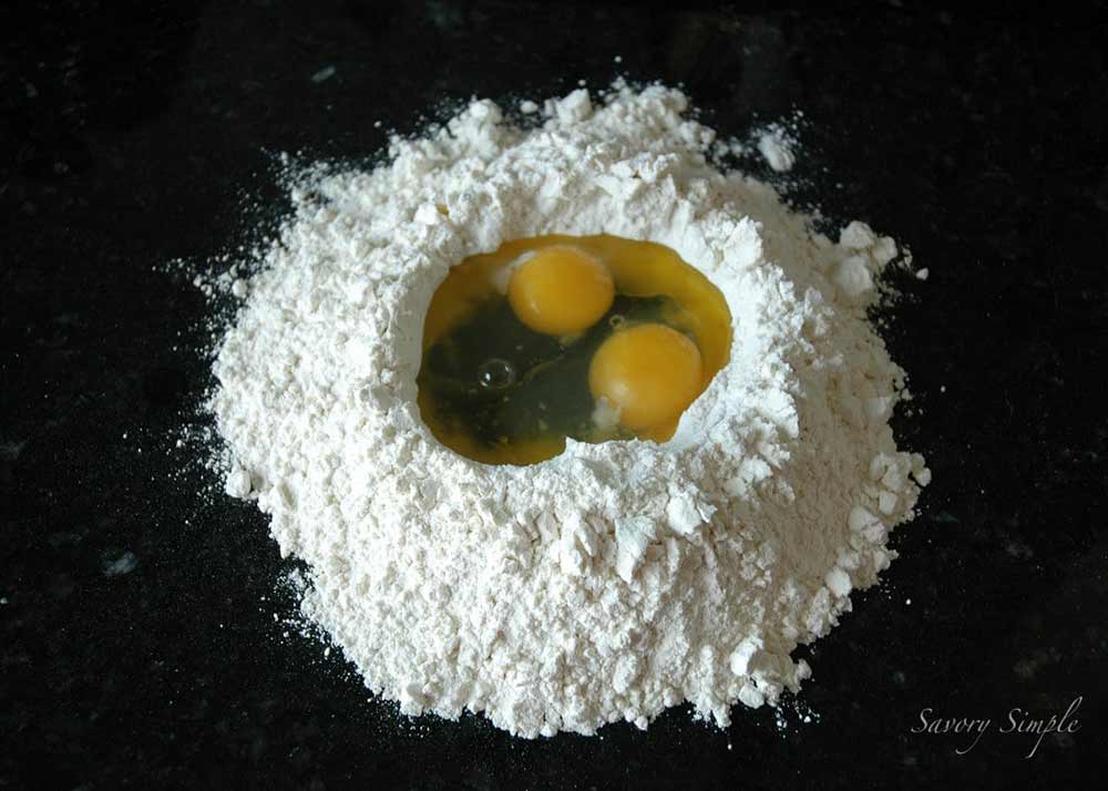 eggs in a flour well for pumpkin ravioli