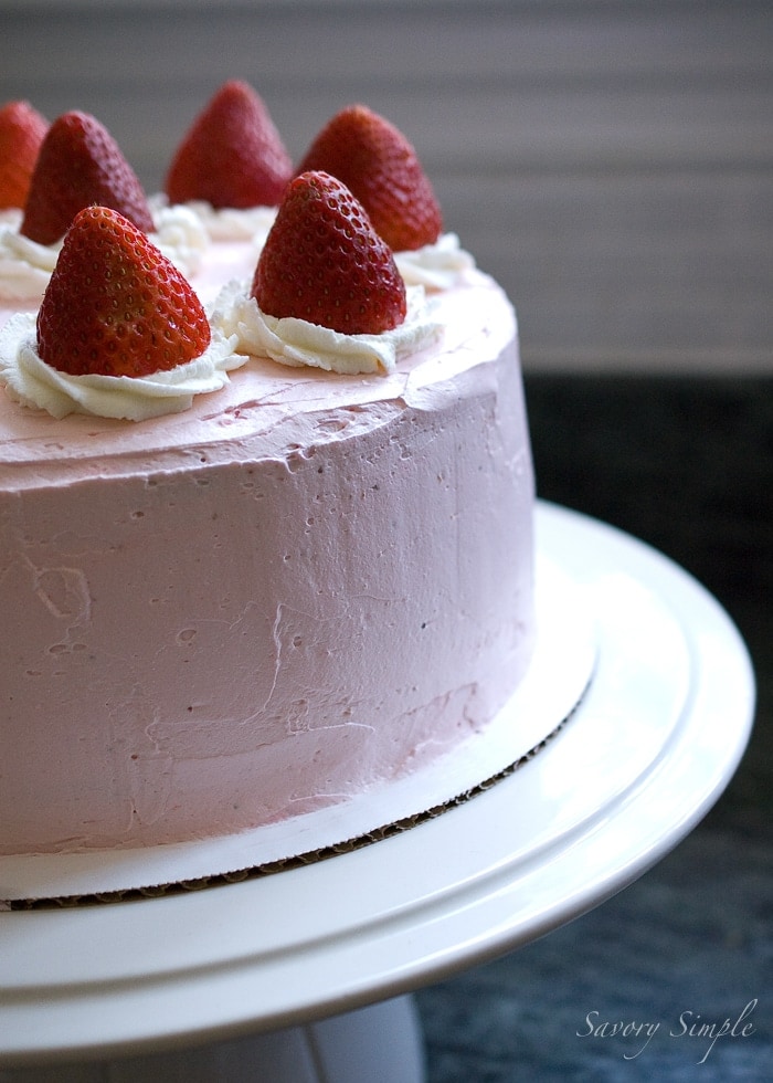 Strawberry Cake ~ Savory Simple Strawberry Cake on a white stand, topped with whipped cream and fresh strawberries.
