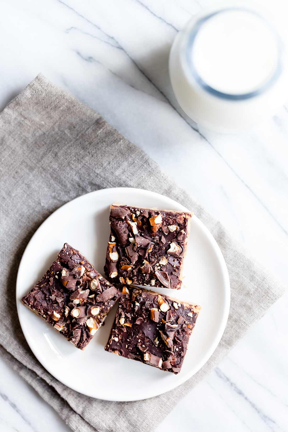 Chocolate Peanut Butter Blondies on a plate next to milk