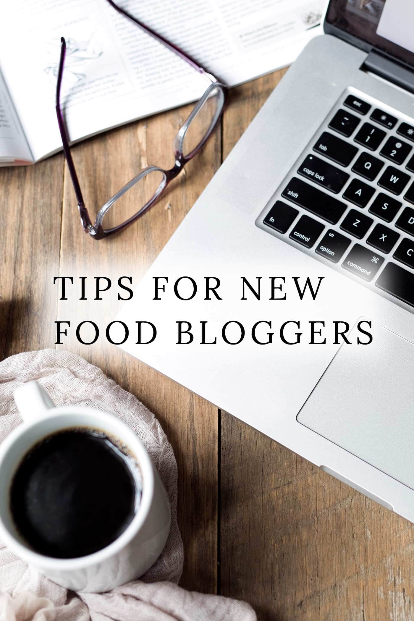  A laptop, coffee, and glasses with text overlay: Food Blogging Tips. 