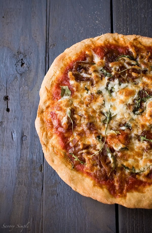 This caramelized onion arugula pizza is an excellent way to use up leftovers for an inexpensive dinner.