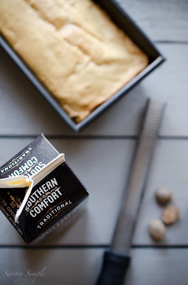 This Eggnog Poundcake with Rum Glaze is moist, dense, sweet and eggy. It's a fabulous holiday dessert! An overhead photo of eggnog pound cake, nutmeg, and Southern Comfort eggnog.
