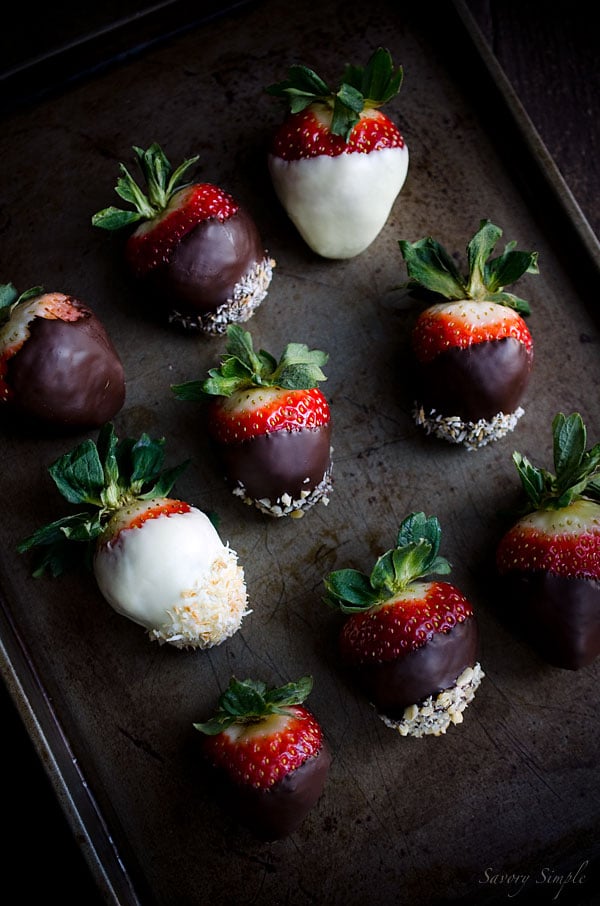A tray with topped with assorted chocolate covered strawberries