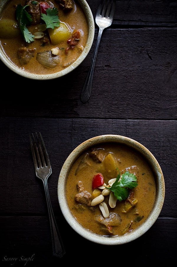 Chicken Massaman Curry is an easy, gluten-free weeknight dinner option. Homemade Thai curry in bowls, shown from overhead on a dark background.