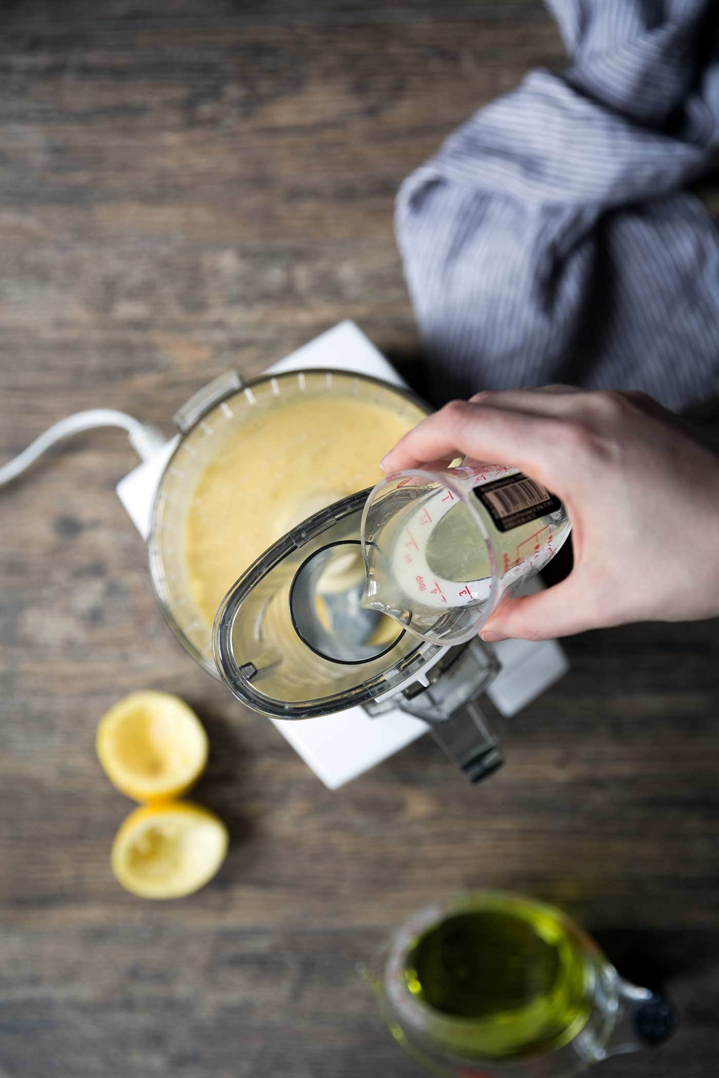 A photo of lemon juice being added to homemade mayo