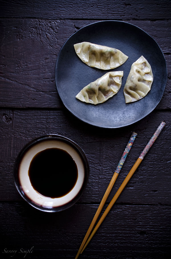 Cooked mushroom dumplings with dipping sauce.