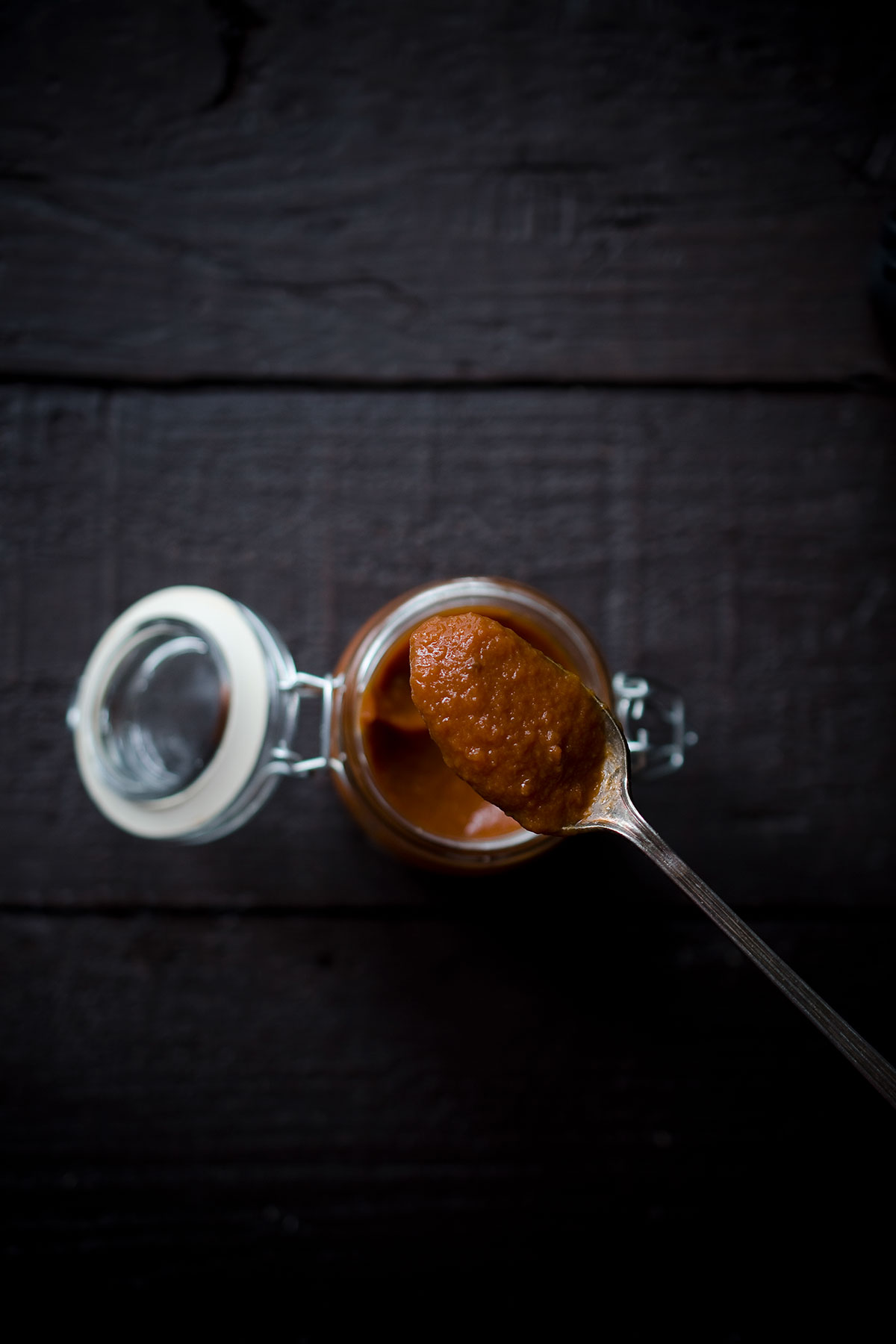 A spoon showing a closeup of this homemade tomato ketchup recipe