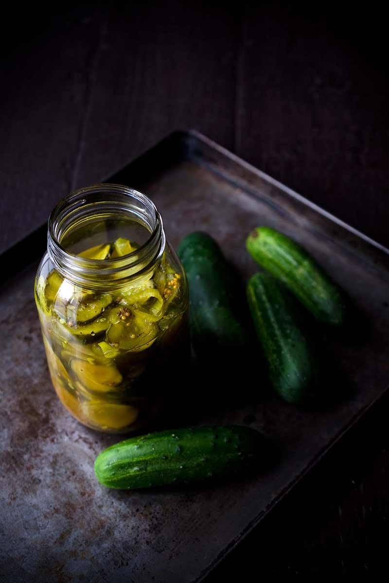 side angle of homemade bread and butter pickles on a tray
