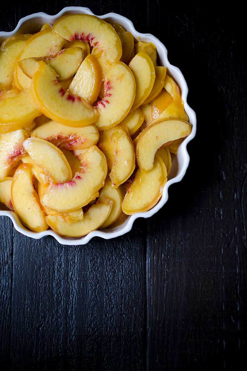 A dish filled with sliced nectarines
