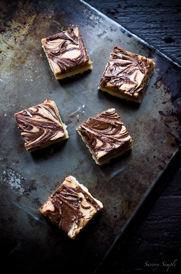 Nutella Cheesecake Bars are the perfect dessert! You won't be able to stop eating them! Get this easy to follow recipe from Savory Simple.