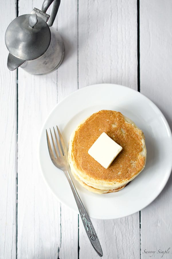 These easy yogurt pancakes are a delicious protein packed breakfast! Get the recipe from SavorySimple.net.