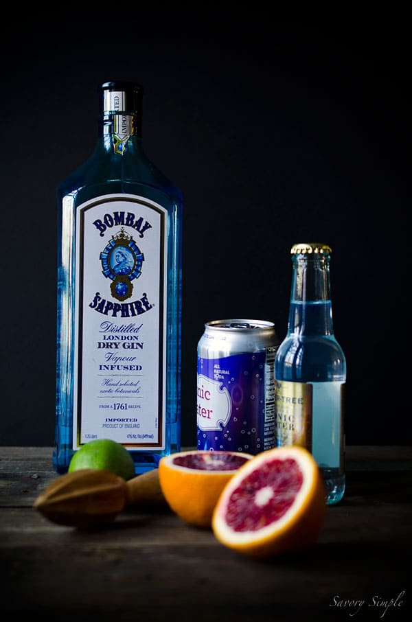 Photo of Gin & Tonic ingredients, including Bombay Sapphire Gin, Whole Foods Tonic, and Fever Tree Tonic, lime.