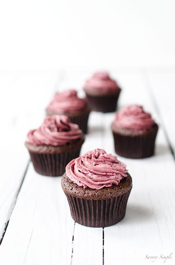 Chocolate Cherry Cupcakes - These rich chocolate cupcakes are topped with a light meringue-based cherry buttercream. Get the recipe from SavorySimple.net.