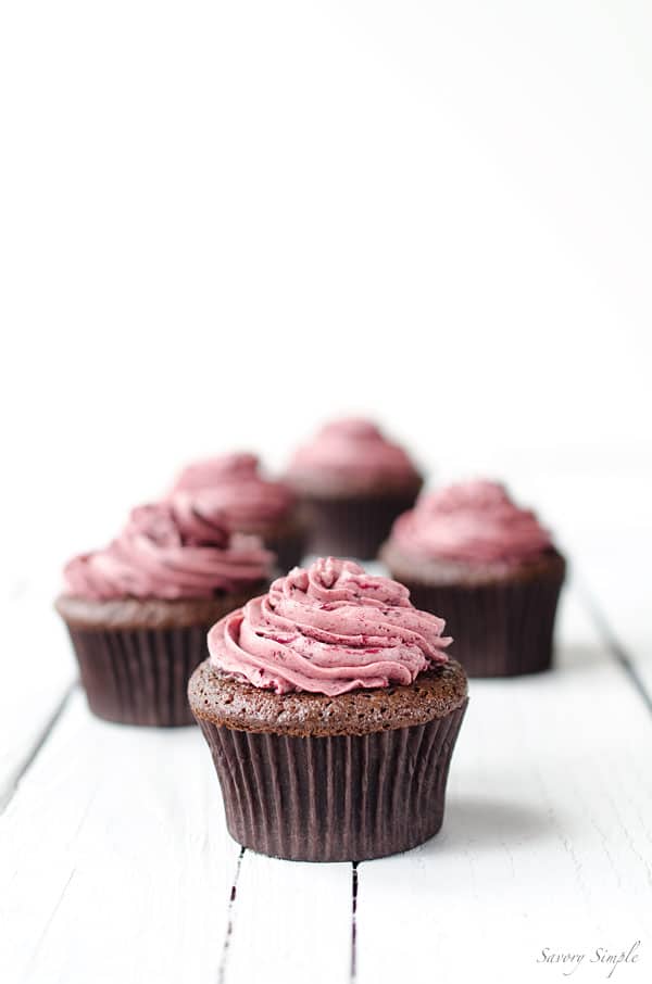 Chocolate Cherry Cupcakes - These rich chocolate cupcakes are topped with a light meringue-based cherry buttercream. Get the recipe from SavorySimple.net.