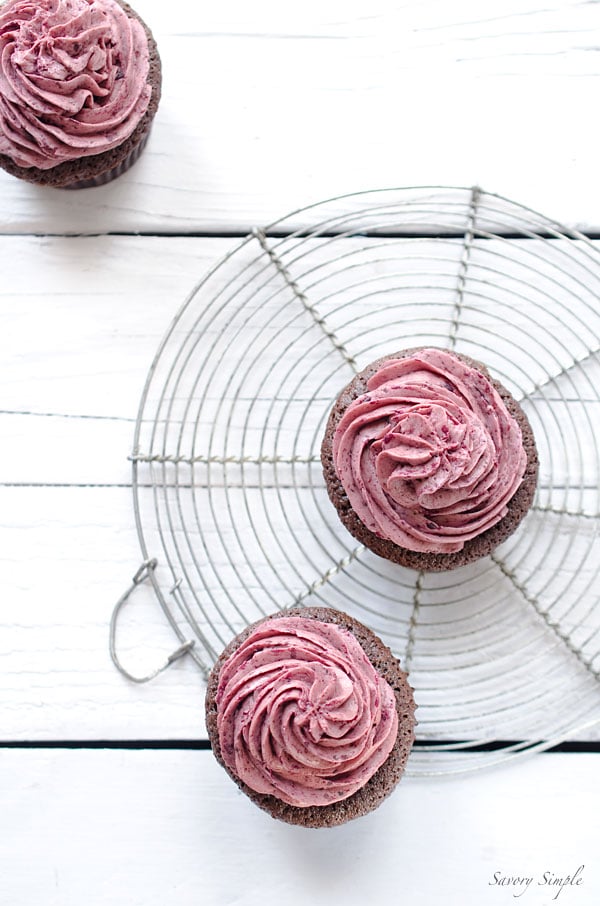 Chocolate Cherry Cupcakes - These rich chocolate cupcakes are topped with a light meringue-based cherry buttercream. Get the recipe from SavorySimple.net.