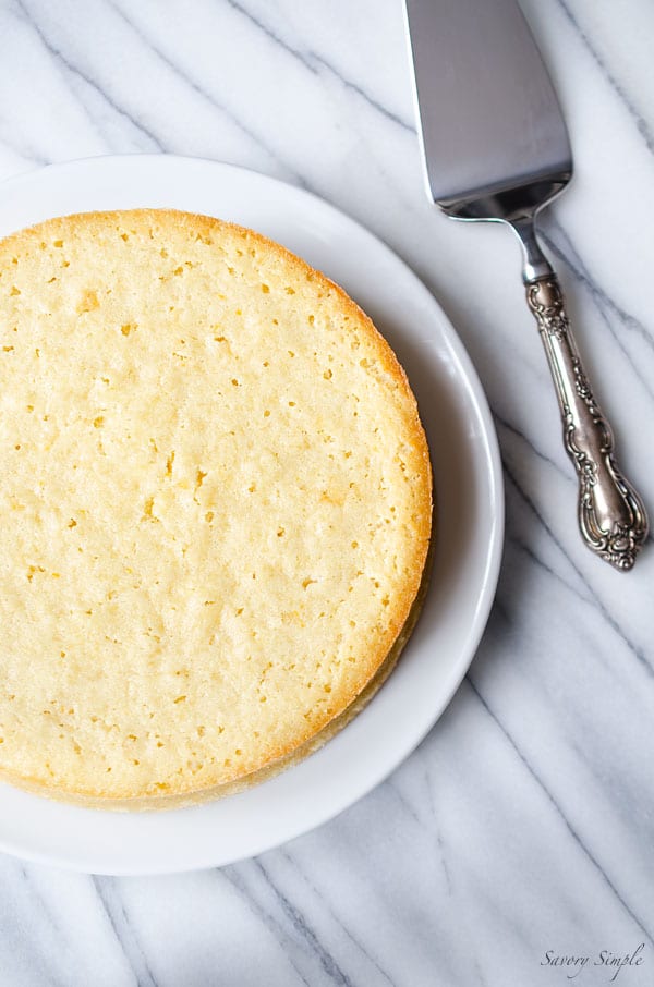 An overhead photo of pineapple cake on a marble backdrop.