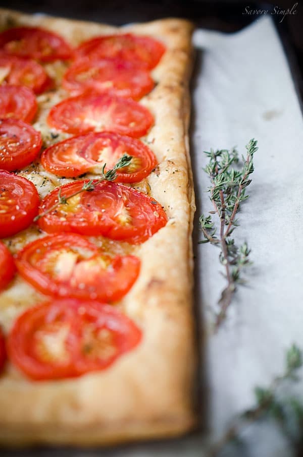 This simple tomato tart is made with only 4 ingredients: tomatoes, puff pastry, roasted garlic and fresh thyme. Get this seasonal, flavorful appetizer recipe from SavorySimple.net