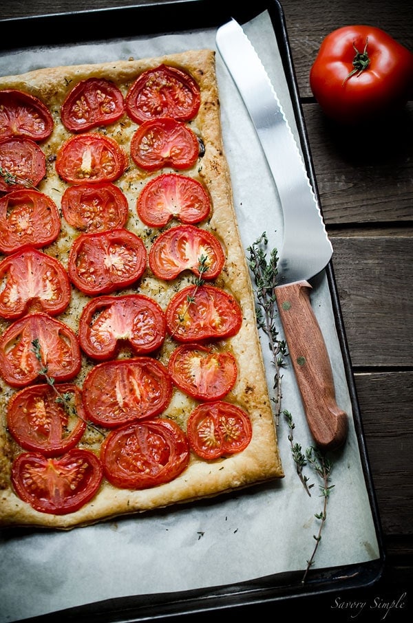 This simple tomato tart is made with only 4 ingredients: tomatoes, puff pastry, roasted garlic and fresh thyme. Get this seasonal, flavorful appetizer recipe from SavorySimple.net