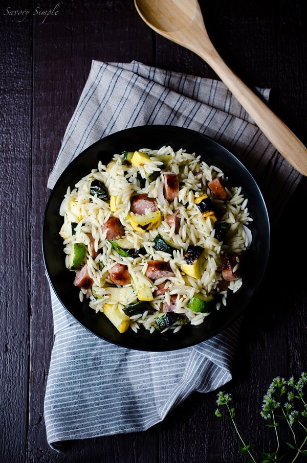 This Grilled Italian Sausage and Vegetable Orzo Salad is all about summer grilling! Smokey, charred vegetables add a ton of flavor to this meaty pasta salad. It's ready in just 30 minutes. Get the recipe from SavorySimple.net.