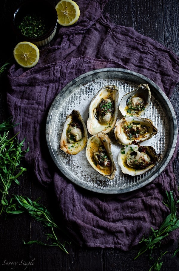 Grilled Oysters with Chipotle Tarragon Butter and Gremolata are a fun and flavorful summer treat! You’ll never want plain oysters again! Get the recipe from SavorySimple.net