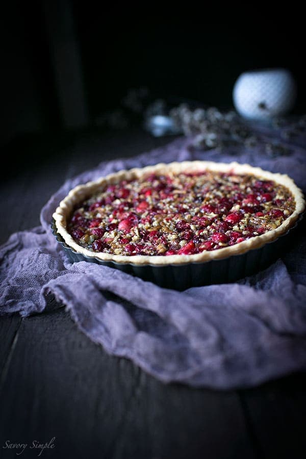 Serve this flavorful Cranberry Pecan Tart at holiday parties! It's perfect for Thanksgiving. Get the easy-to-prepare recipe from SavorySimple.net
