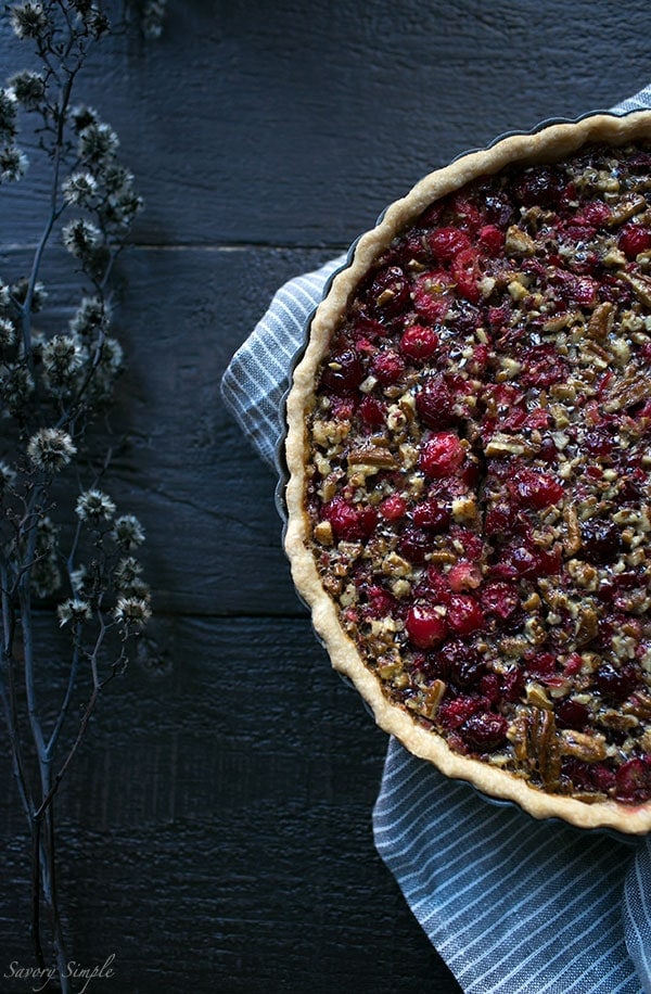 Serve this flavorful Cranberry Pecan Tart at holiday parties! It's perfect for Thanksgiving. Get the easy-to-prepare recipe from SavorySimple.net