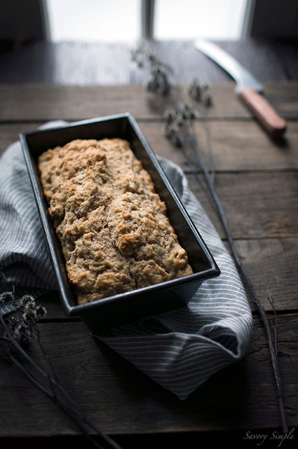 A photo of pumpkin beer bread sitting in a loaf pan.