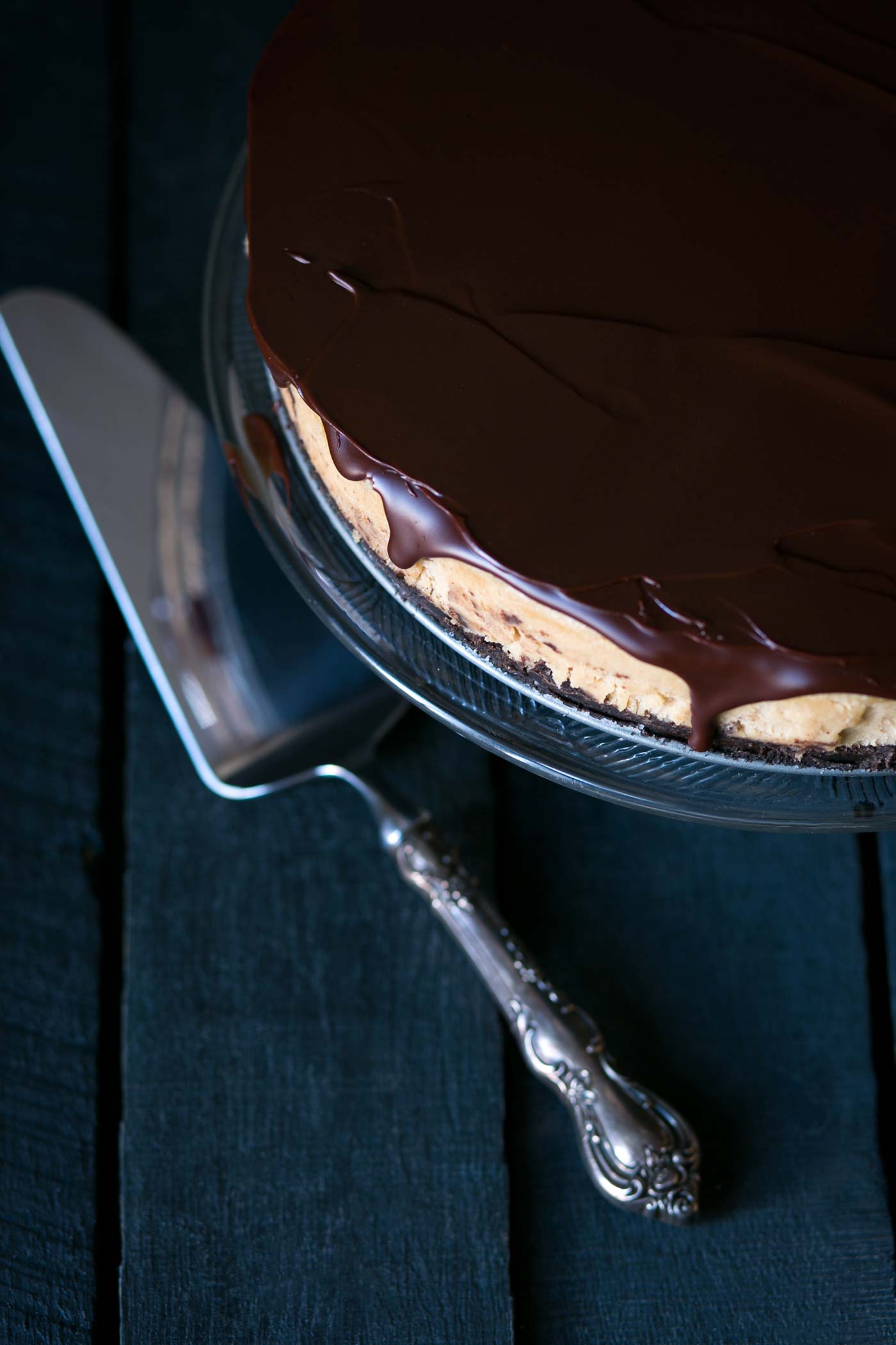 This decadent Chocolate Peanut Butter Cheesecake has a chocolate graham cracker crust, a light and fluffy peanut butter filling, and is topped with a bittersweet chocolate ganache. Get the recipe from SavorySimple.net