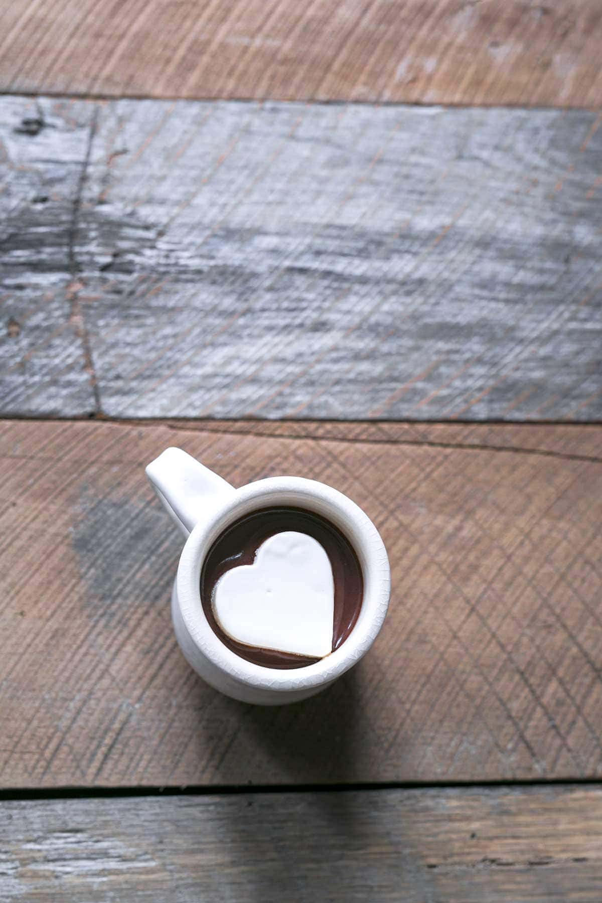 A mug full of homemade hot chocolate topped with a heart