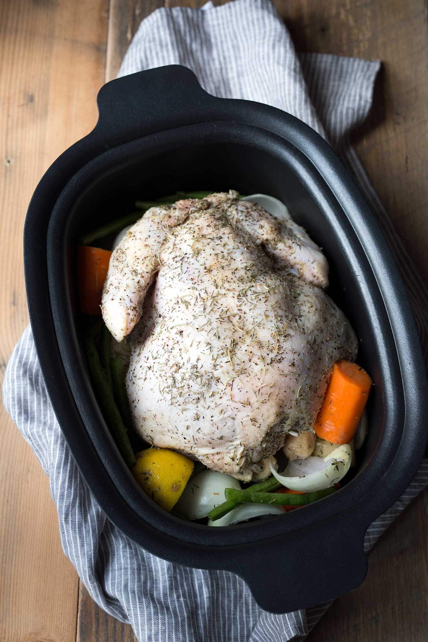 Lemon-Herb Slow Cooker Whole Chicken is an easy "set it and forget it" meal. A few minutes of prep time is all you need for a flavor-packed dinner! SavorySimple.net
