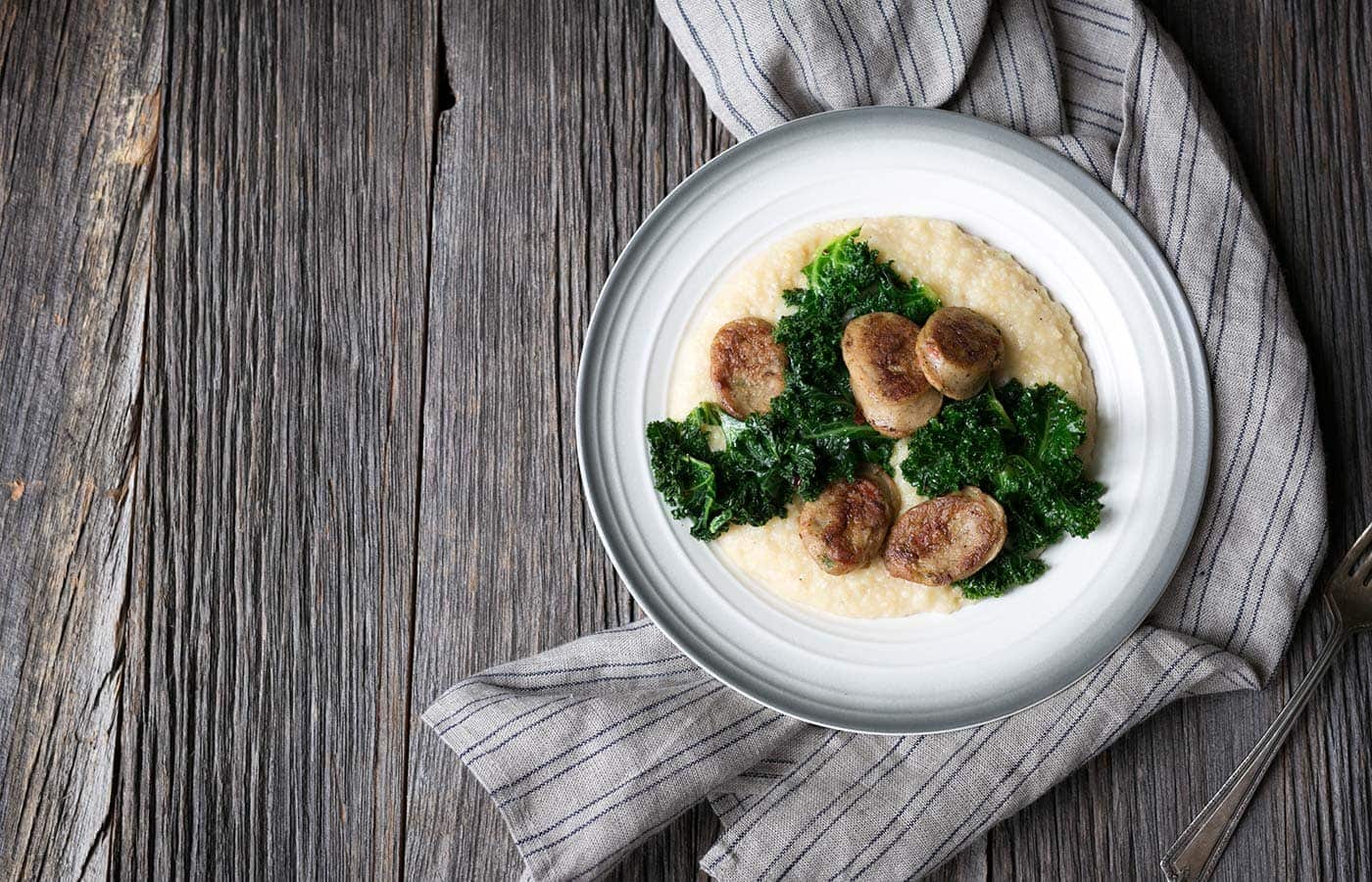 A photo of the finished creamy polenta with sausage and kale dish