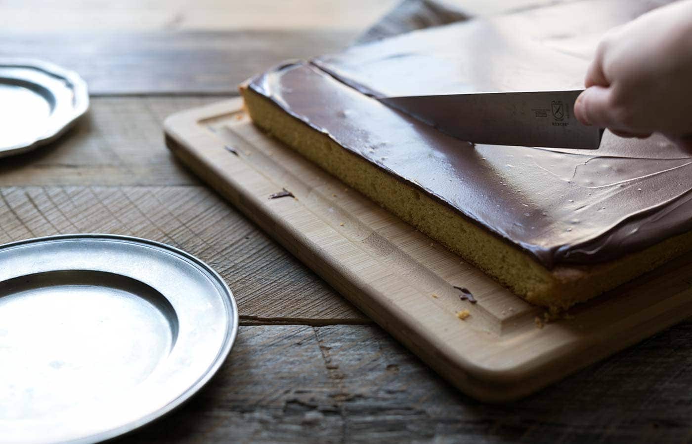 Yellow Sheet Cake with Chocolate Sour Cream Frosting is a perfect cake to serve at parties! The cake is tender, the frosting is sweet and tangy, and the entire thing can be prepped in advance. SavorySimple.net