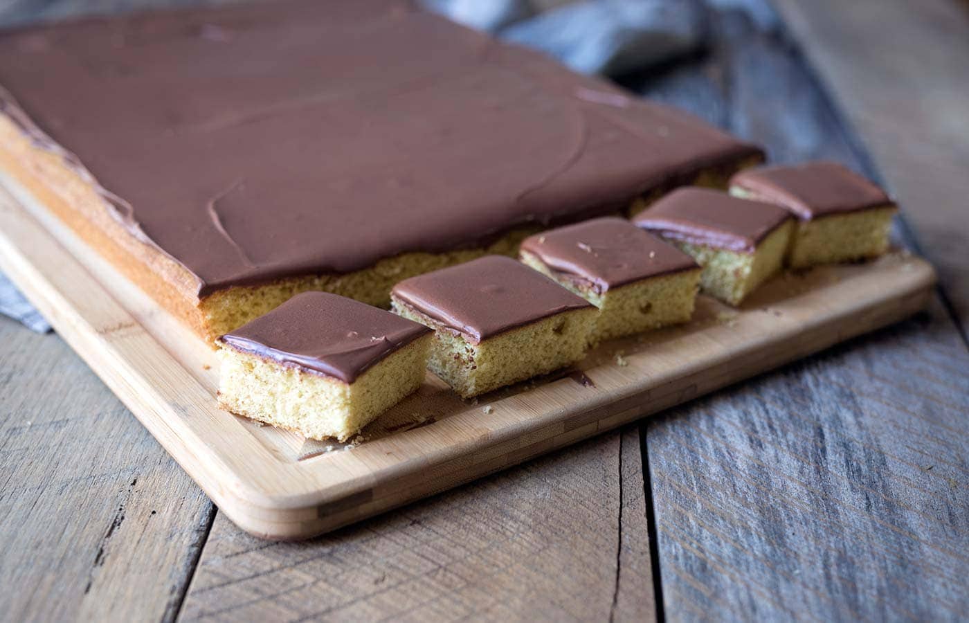 Yellow Sheet Cake with Chocolate Sour Cream Frosting is a perfect cake to serve at parties! The cake is tender, the frosting is sweet and tangy, and the entire thing can be prepped in advance. SavorySimple.net