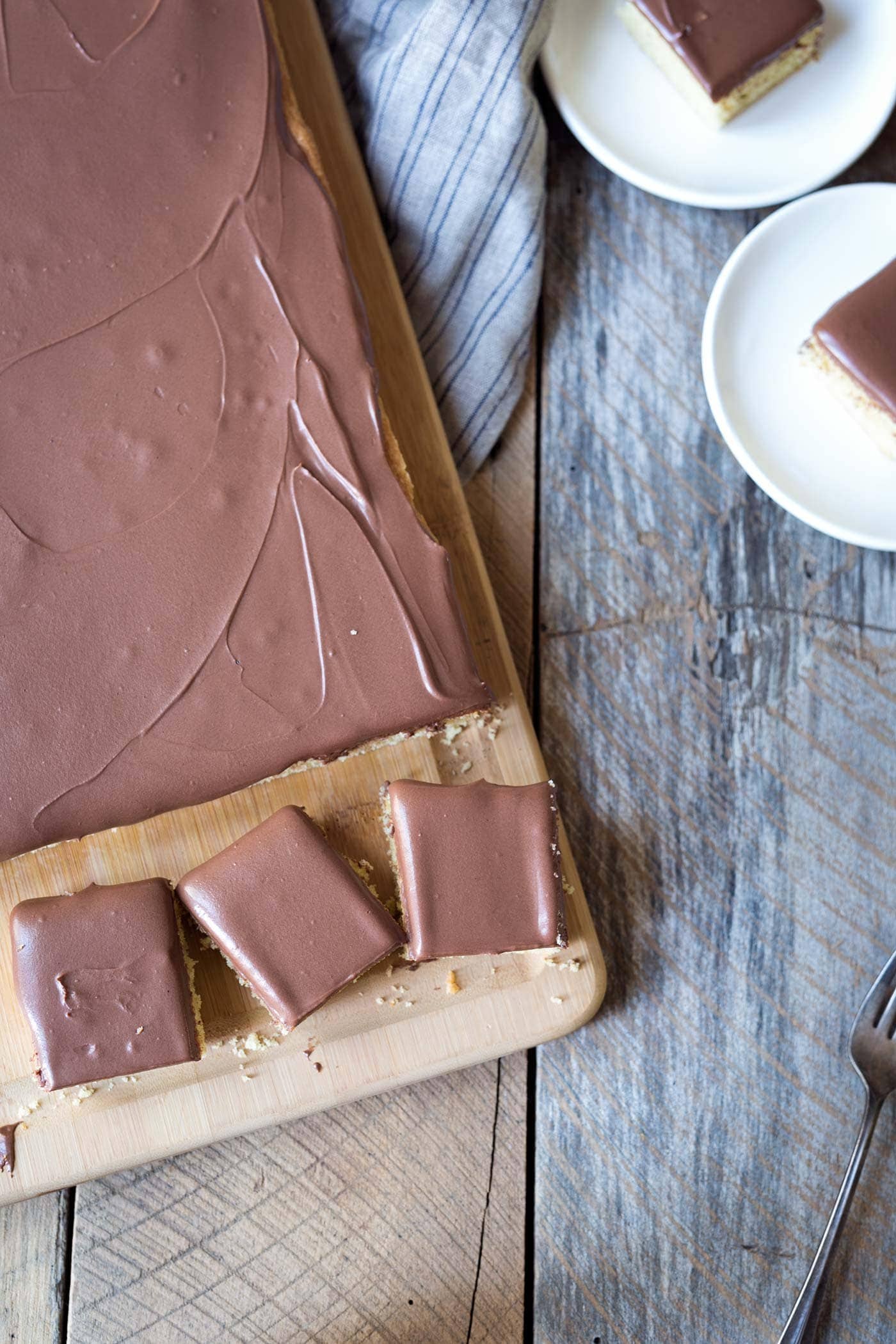 Yellow Sheet Cake with Chocolate Sour Cream Frosting is a perfect cake to serve at parties! The cake is tender, the frosting is sweet and tangy, and the entire thing can be prepped in advance. SavorySimple.net