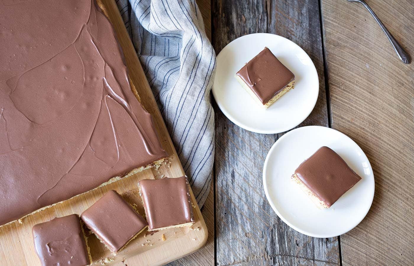 Yellow Sheet Cake with Chocolate Sour Cream Frosting is a perfect cake to serve at parties! The cake is tender, the frosting is sweet and tangy, and the entire thing can be prepped in advance. SavorySimple.net