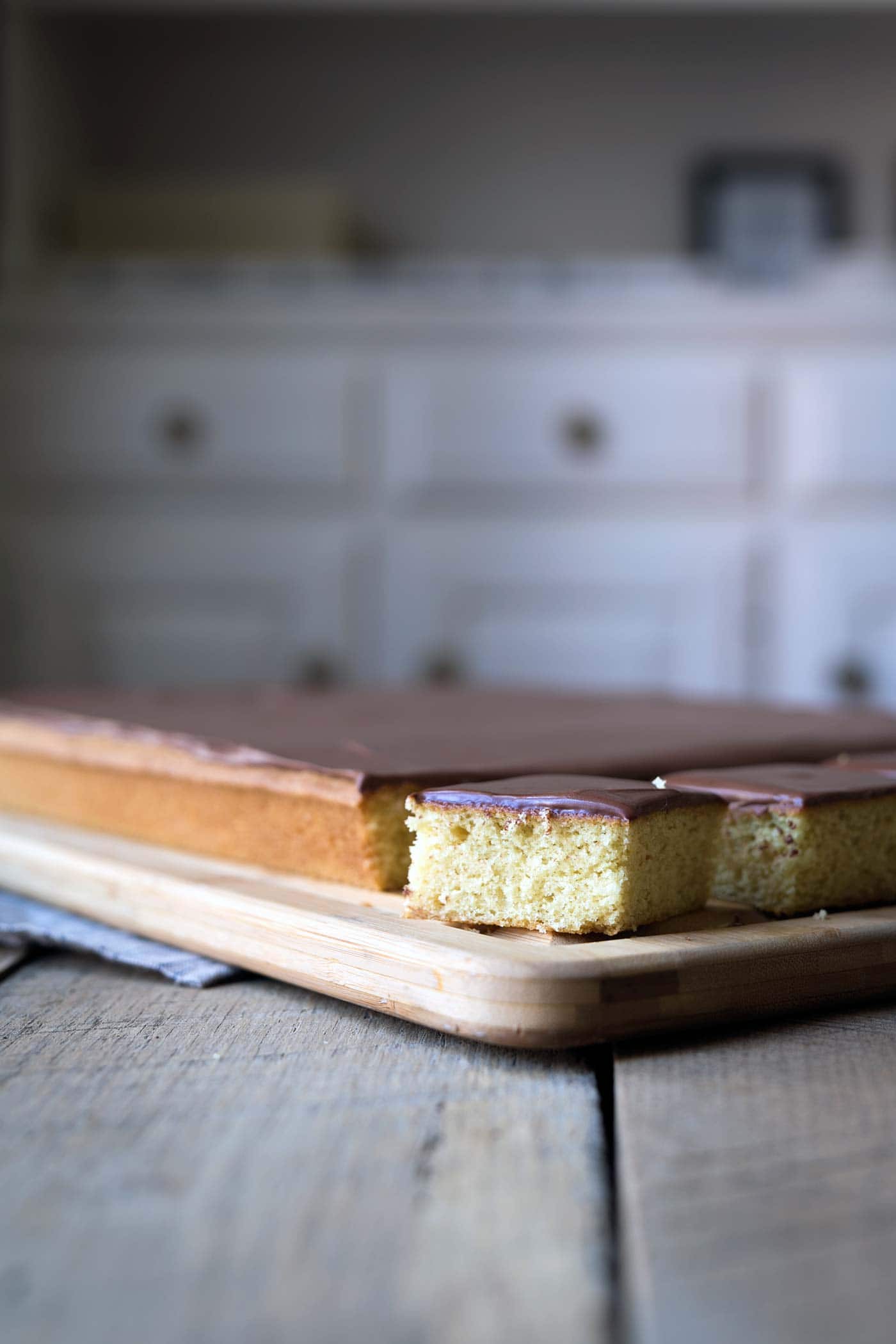 Yellow Sheet Cake with Chocolate Sour Cream Frosting is a perfect cake to serve at parties! The cake is tender, the frosting is sweet and tangy, and the entire thing can be prepped in advance. SavorySimple.net