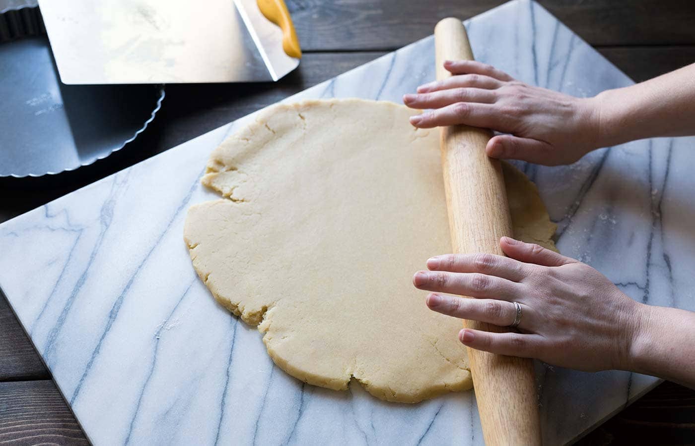 Rolling out dough on a marble board.