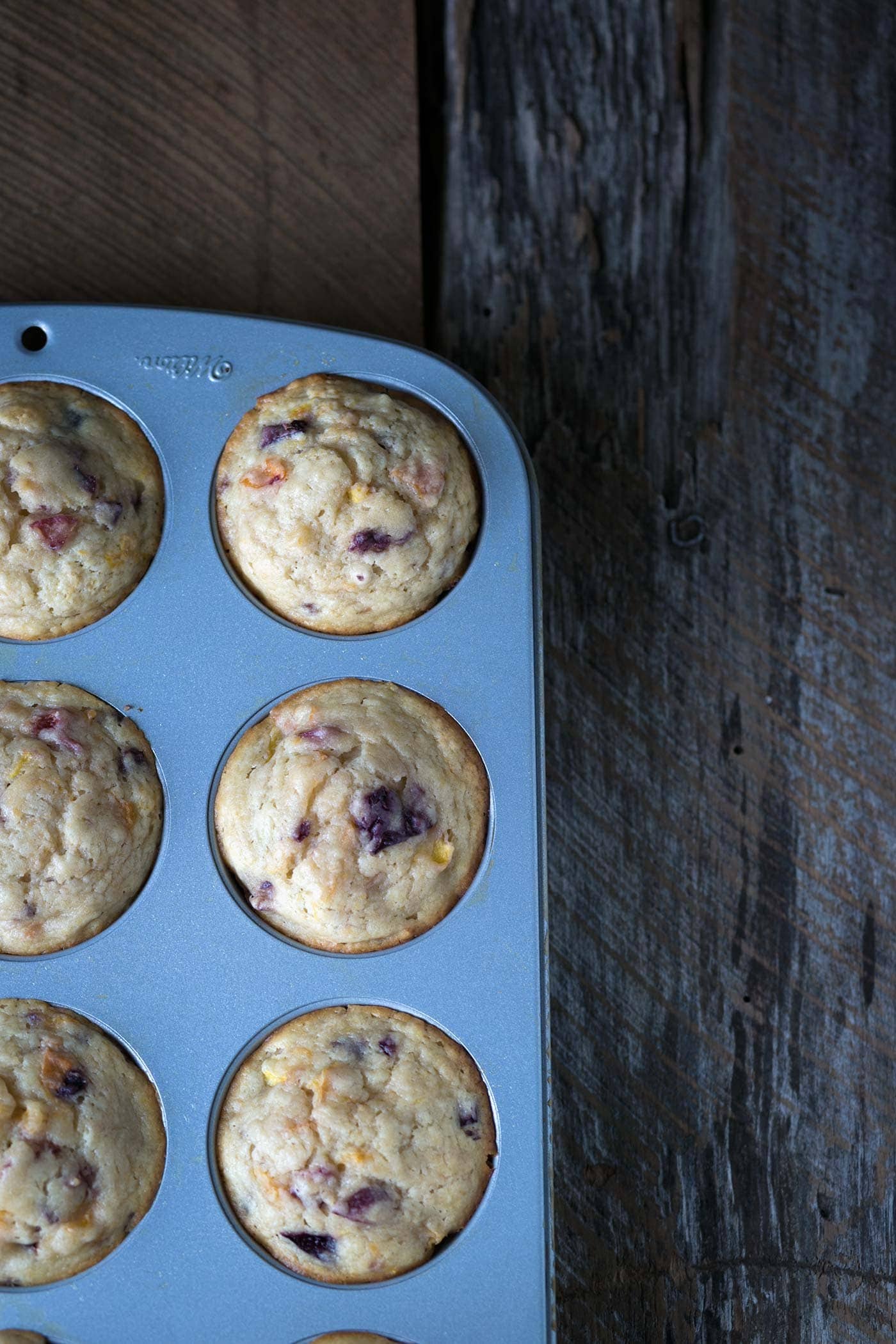 Stone Fruit Yogurt Muffins are incredibly soft, moist, and easy to prepare. Bursting with summer flavor, these delicate treats are a perfect addition to the breakfast table. SavorySimple.net