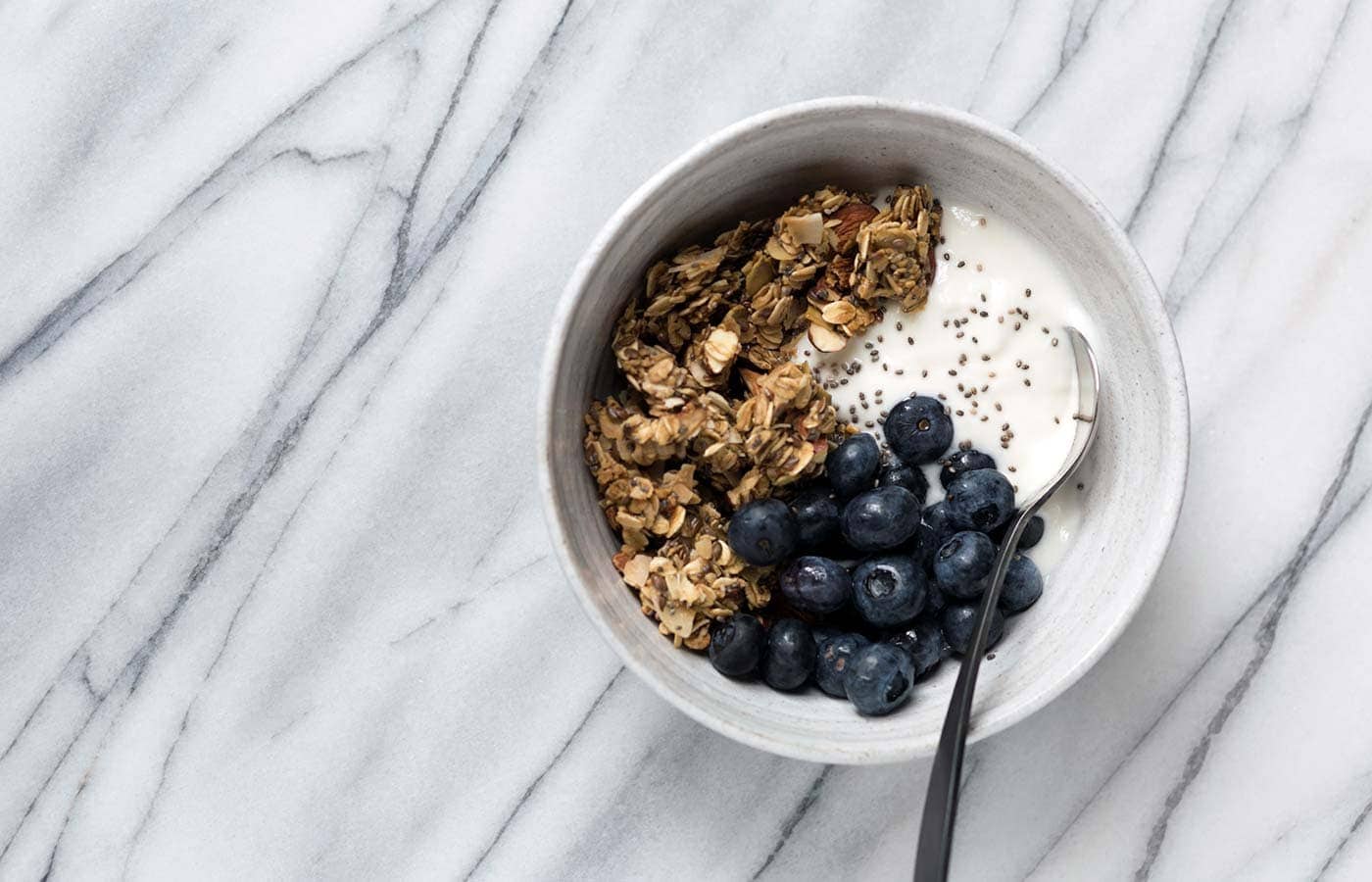 This Granola Yogurt Breakfast Bowl features an easy homemade granola that can be prepared in advanced for weeks worth of quick, delicious, healthy breakfasts. SavorySimple.net