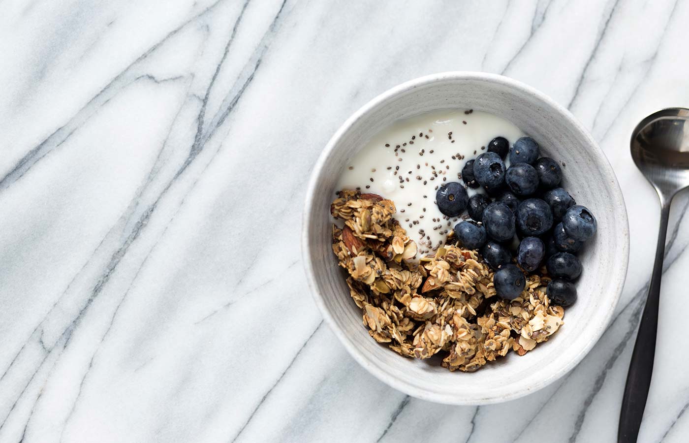 This Granola Yogurt Breakfast Bowl features an easy homemade granola that can be prepared in advanced for weeks worth of quick, delicious, healthy breakfasts. SavorySimple.net