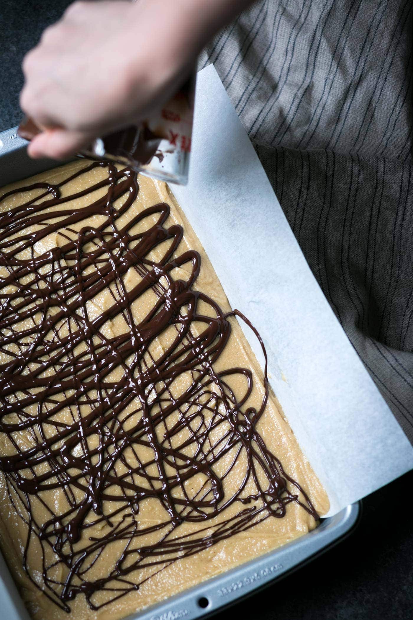 These decadent Salted Chocolate-Swirled Tahini Cashew Bars are soft, rich, and a perfect balance of flavors. Perfect for parties! SavorySimple.net