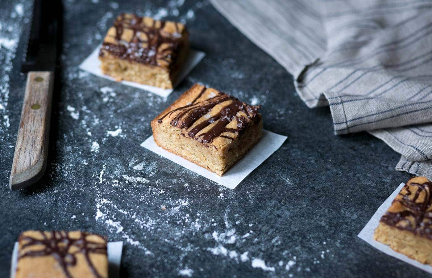 These decadent Salted Chocolate-Swirled Tahini Cashew Bars are soft, rich, and a perfect balance of flavors. Perfect for parties! SavorySimple.net