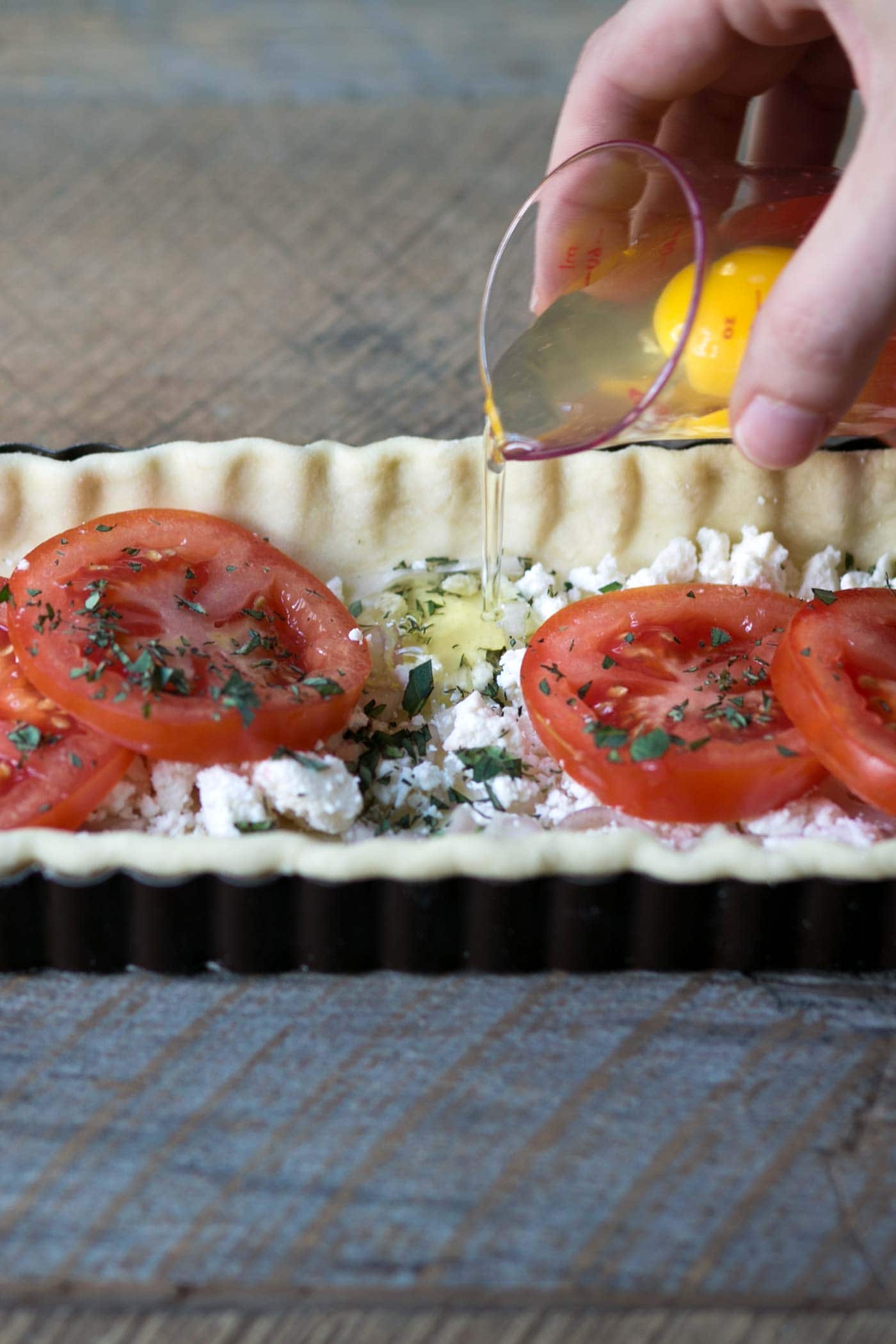This Tomato Feta Egg Tart is perfect as an appetizer, side dish, or even for breakfast. It’s beautiful and incredibly delicious. SavorySimple.net