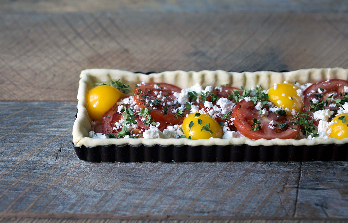 This Tomato Feta Egg Tart is perfect as an appetizer, side dish, or even for breakfast. It’s beautiful and incredibly delicious. SavorySimple.net