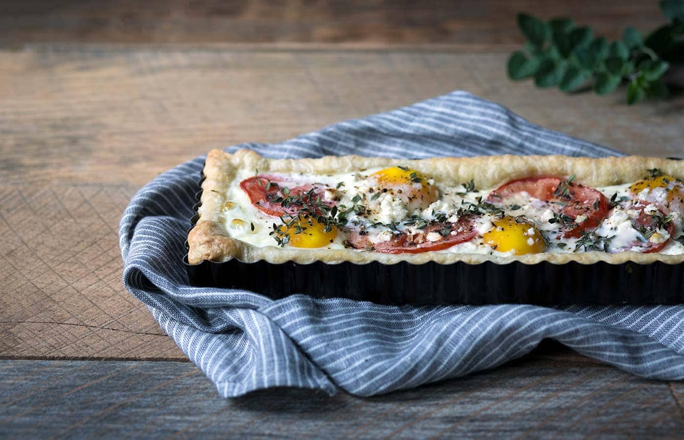This Tomato Feta Egg Tart is perfect as an appetizer, side dish, or even for breakfast. It’s beautiful and incredibly delicious. SavorySimple.net