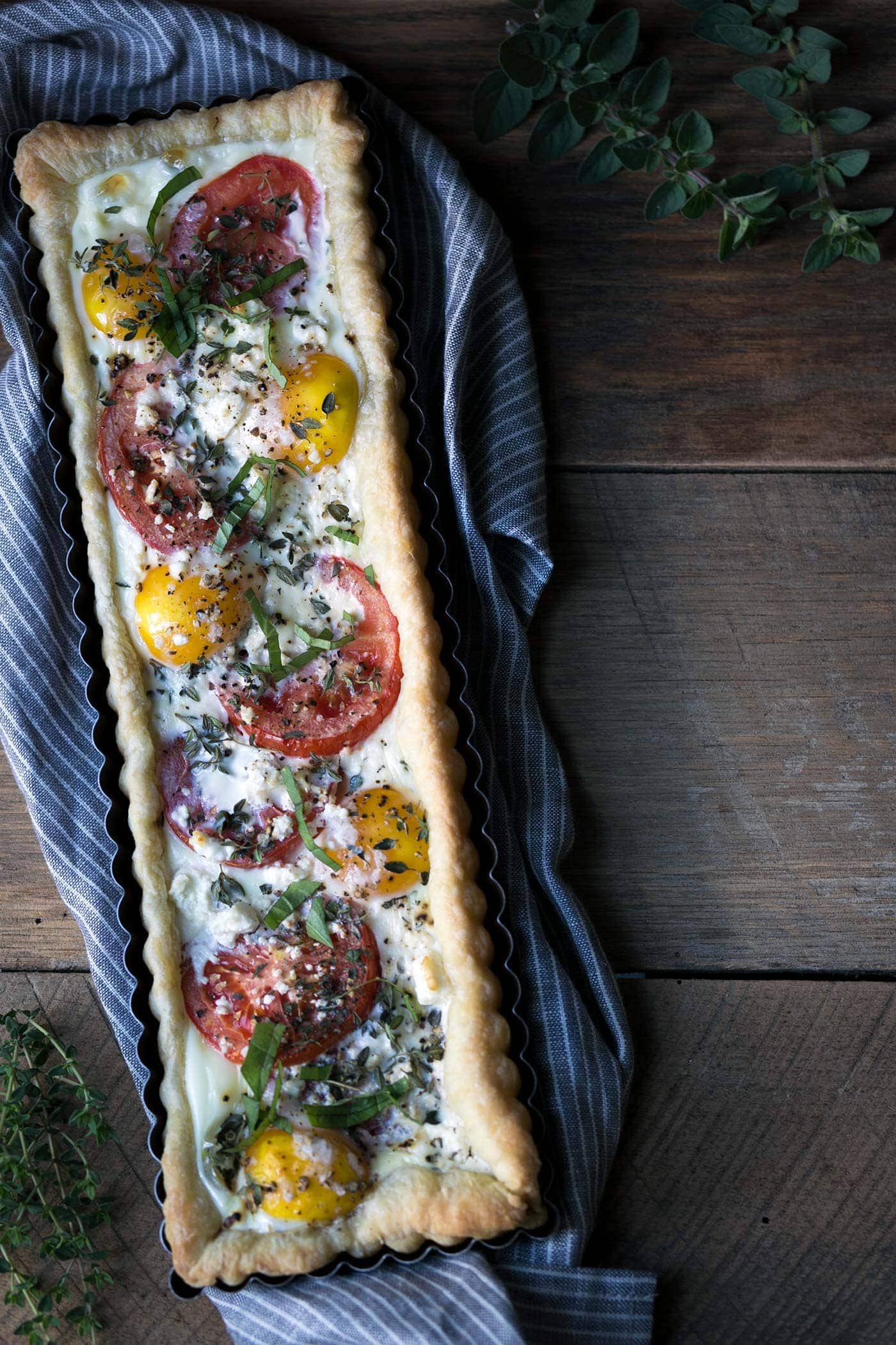 This Tomato Feta Egg Tart is perfect as an appetizer, side dish, or even for breakfast. It’s beautiful and incredibly delicious. SavorySimple.net