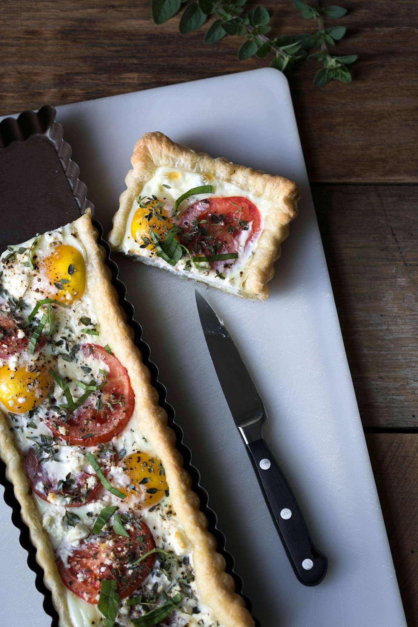 This Tomato Feta Egg Tart is perfect as an appetizer, side dish, or even for breakfast. It’s beautiful and incredibly delicious. SavorySimple.net