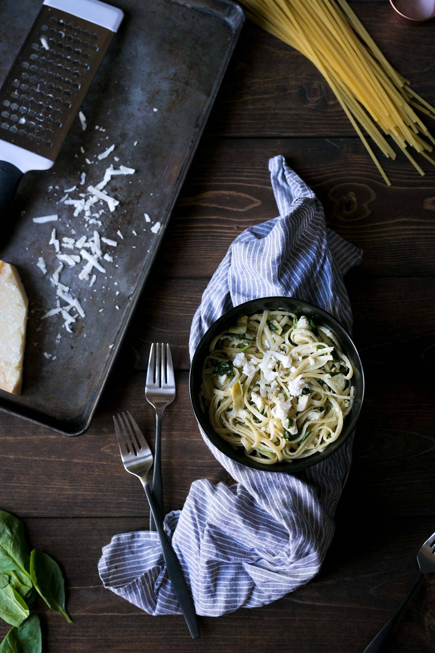 Cheesy Spinach and Artichoke Pasta is a simple, comforting meal that comes together in less than 20 minutes. Only 6 ingredients! SavorySimple.net